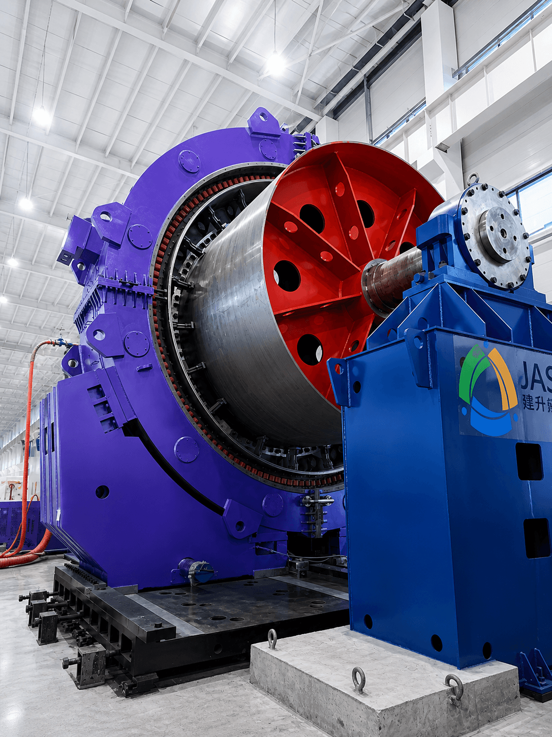 Massive purple industrial machine with a red rotor in a brightly lit modern factory.